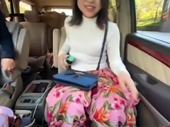 Hot Japanese babe gets her juicy peach fingered in the car