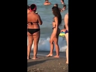 Sexy slender brunette teen enjoying the hot sun on the beach