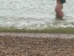 Shy nudist girl at the beach