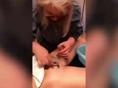 Woman Trimming and Shaving Male Client