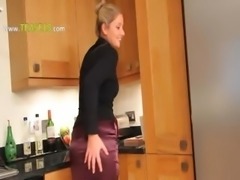 Blonde woman in kitchen teasing hard
