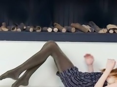 Ultra skinny teen by the fireplace