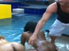 Two dark skinned babes, Brown Sugar and Goddness get naked by the pool and let Billy Glide oil them up. After, their fun takes them to the bedroom where he gets a double blowjob.