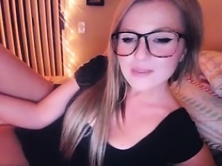 Stunning blonde with glasses rubs her huge amazing boobs fo