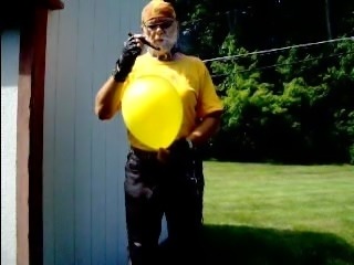 LeatherBiker bitch popping a yellow balloon with her cigar