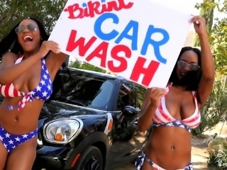 Two chocolate girls from America giving a good wash to that car