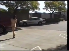 Naked girl walking through a parking garage
