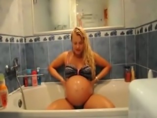 Stunning prego GF taking shower in tempting bikini