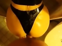 Me pummeling my wife's large damp caboose in latex strings 