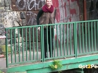 Dirty-minded auburn chick is caught on cam pissing outdoors in various places