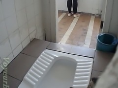 Brunette amateur chick filmed from behind in the toilet room