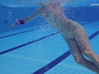 Alluring blondie Elena Proklova swimming in a pool naked