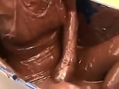Asian chick climbs into a tub full of chocolate and gets to