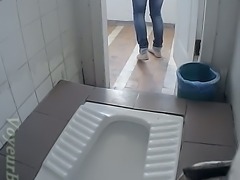 Lovely white chick in jeans pisses in the public restroom