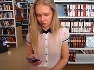 Slim and sexy blonde stripping in public library