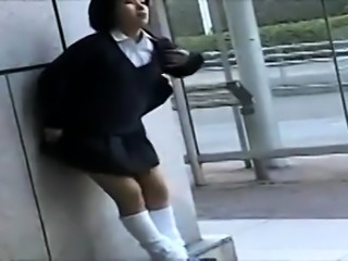 Naughty Japanese schoolgirl in uniform reveals her sweet ass