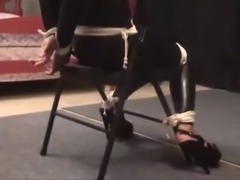 Girl tied to chair and gagged in catsuit
