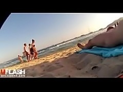 Girls enjoy nude guy view on Beach