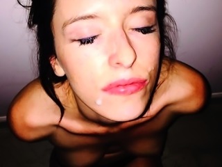Sensuous young brunette gets her face sprayed with hot cum