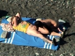 Voyeur video of sexy brunette nude hottie at the beach