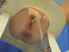 girl sets a toilet seat over two chairs and pissies on the ground. Great...