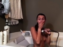 Horny teen with small boobs masturbates in the bathtub